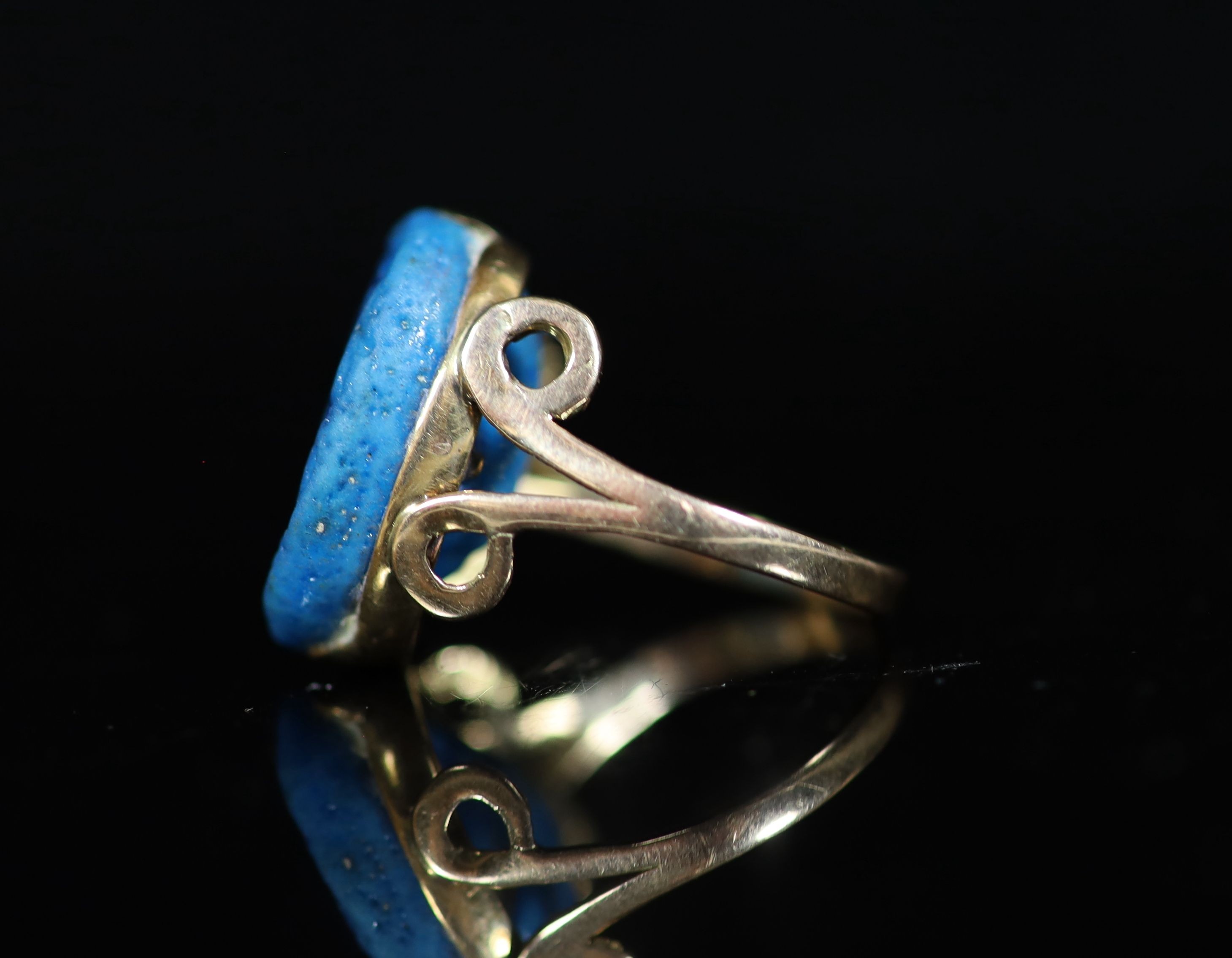 An antique gold and oval turquoise glazed intaglio set ring